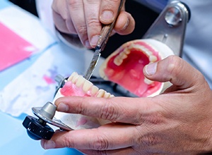 close-up of dental lab technician working on dentures