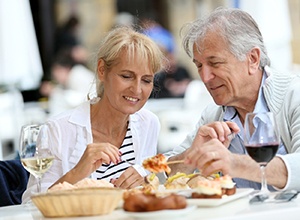senior couple enjoying meal together at outdoor café