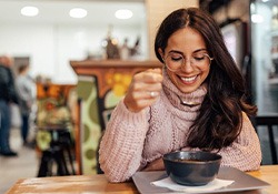 Smiling woman eating in a café