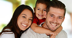 Smiling mother and father with young child