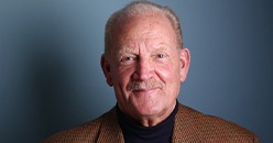 Smiling older man in brown jacket