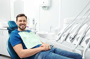 Happy male patient in dental treatment chair