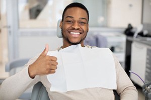 Dental patient making thumbs up gesture