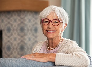 Smiling senior woman sitting on sofa