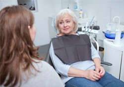 Senior patient talking to dental team member
