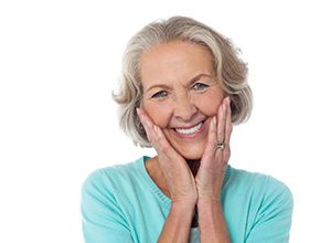 Happy senior woman pictured against white background