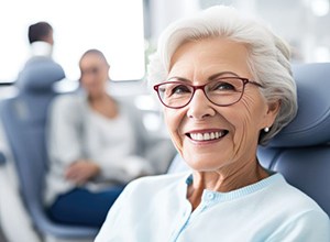 Smiling older woman in dental treatment chair