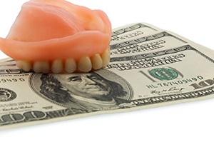 Denture for upper arch, resting on top of money
