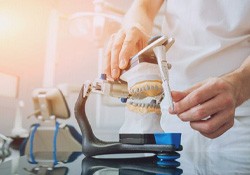 Dental lab technician working with articulator