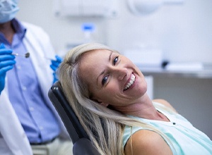 Patient smiling after dental implant failure and salvage in Newington