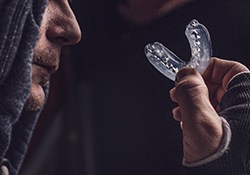 Athlete getting ready to place mouthguard in mouth