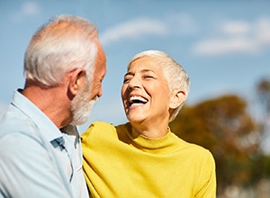 Laughing senior woman with implant dentures in Newington