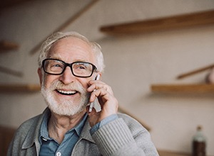 Confident senior man enjoying benefits of implant dentures