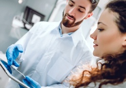 Dentist and patient talking during dental implant consultation