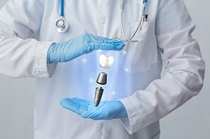 Implant, abutment, and crown floating between gloved hands to represent dental implant technology