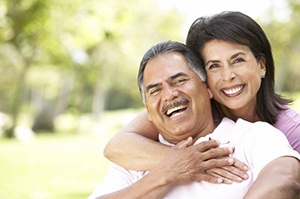 smiling couple with dental implants in Newington