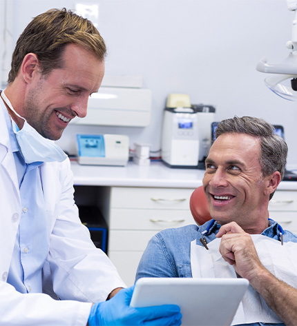 Patient in dental exam room with Newington dentist