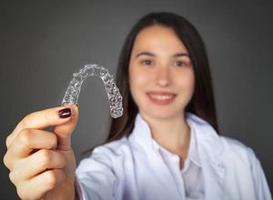 Woman holding invisalign