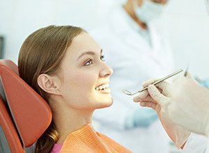 Woman receiving oral cancer screening