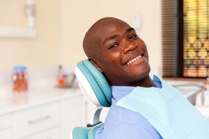 Smiling male patient with questions about root canal therapy in Newington