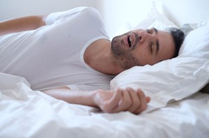 Snoring man in need of sleep apnea therapy in Newington