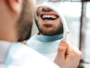 Patient admiring smile after getting tooth-colored filling in Newington