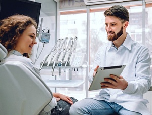 Dentist and patient discussing need for tooth-colored filling