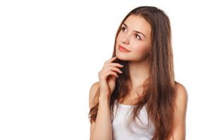 Woman in white shirt, has questions about veneers