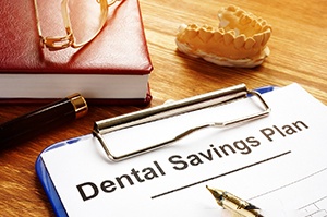 Dental savings plan document attached to clipboard