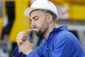 Man thinking about relationship between smoking and dental implants