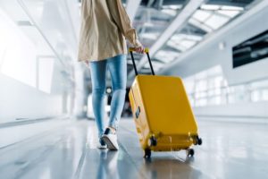 Woman carrying her suitcase through the airport