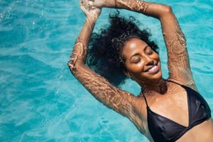 Smiling woman floating in a pool