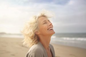 Woman on beach, smiling happily