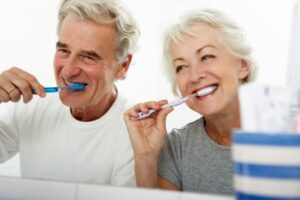 Senior couple brushing their teeth