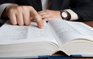 Man looking up terms in a reference book