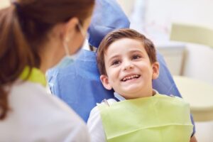 Happy little boy looking at his dentist 