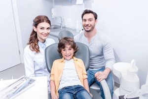 Father and son posing with their family dentist 
